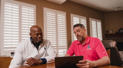 Tech explaining to customer signs that the home needs new insulation