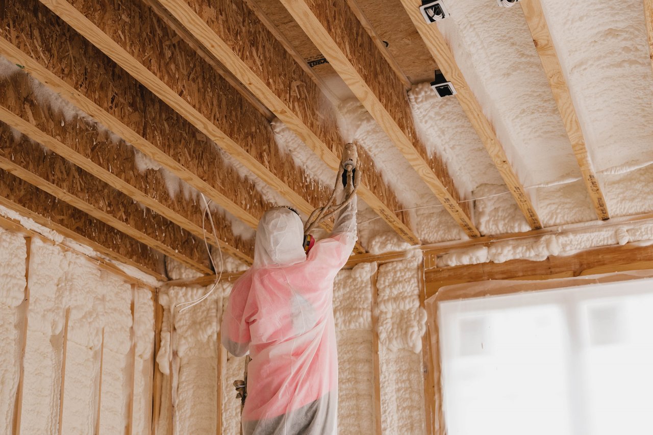 iFOAM Insulation of Delray Beach worker installing spray foam insulation in an attic